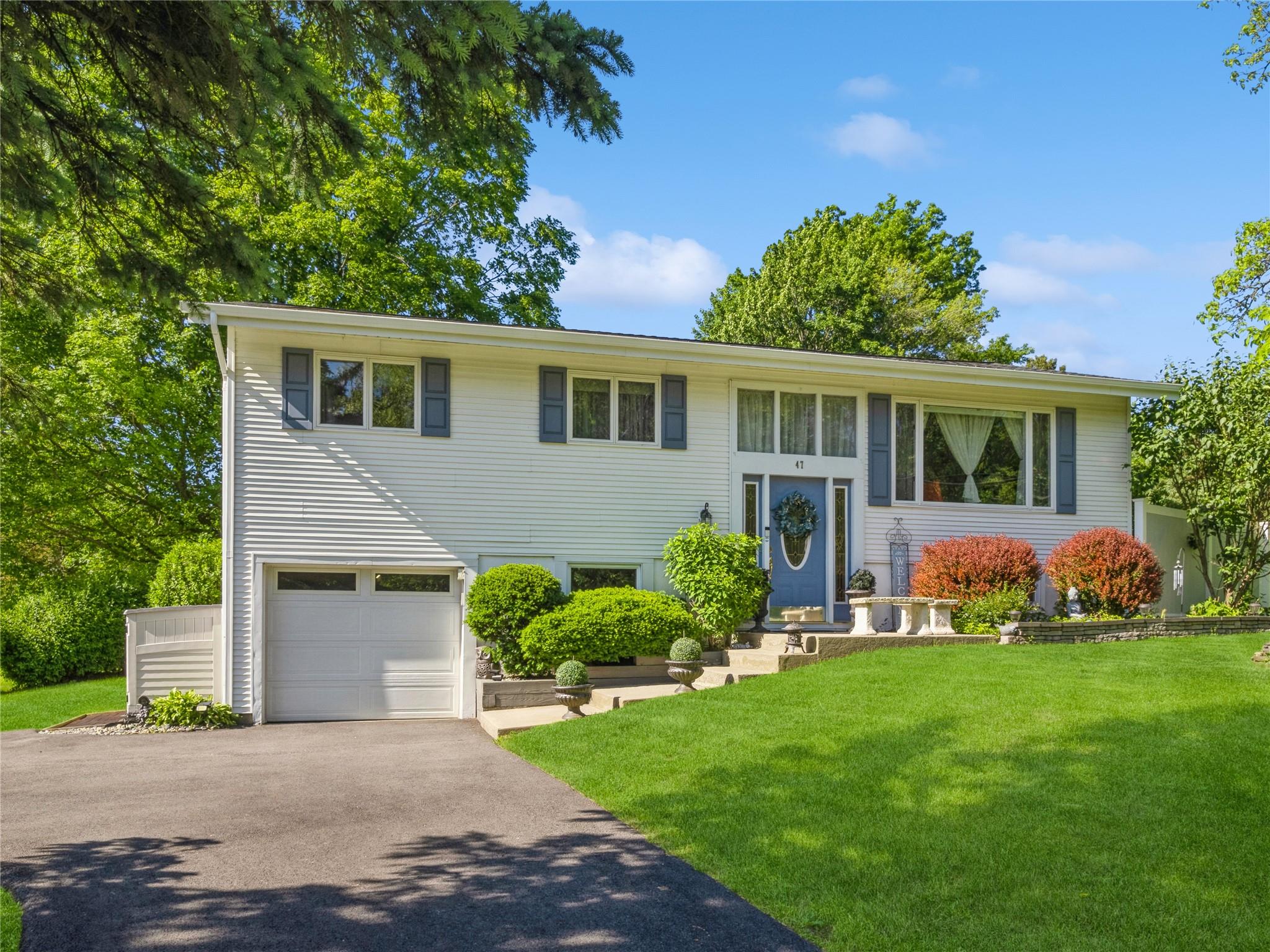 47 Wedgewood Road Fishkill, NY 12524 - Photo 1 of 1 Split foyer home featuring a garage, asphalt driveway, and a front lawn