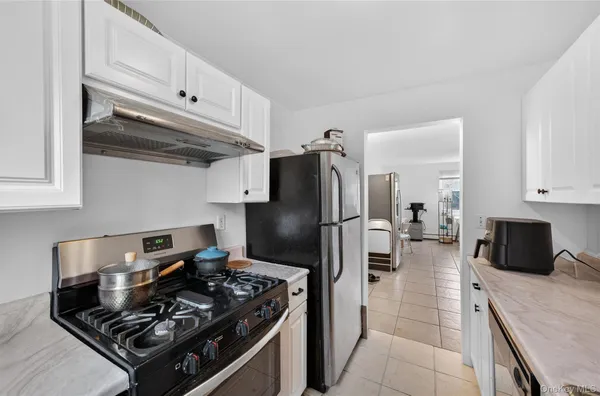 a kitchen with stainless steel appliances granite countertop a stove and a refrigerator
