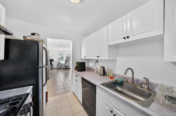 a kitchen with refrigerator and cabinets