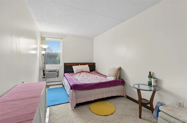 a bedroom with a bed and a table in it