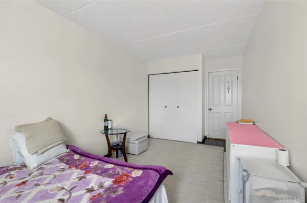 a bedroom with a bed and a chair