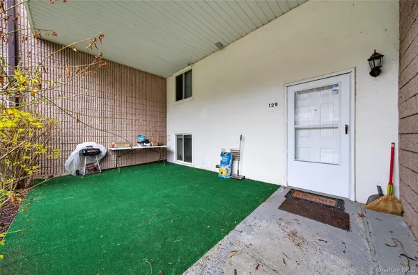 a backyard of a house with table and chairs