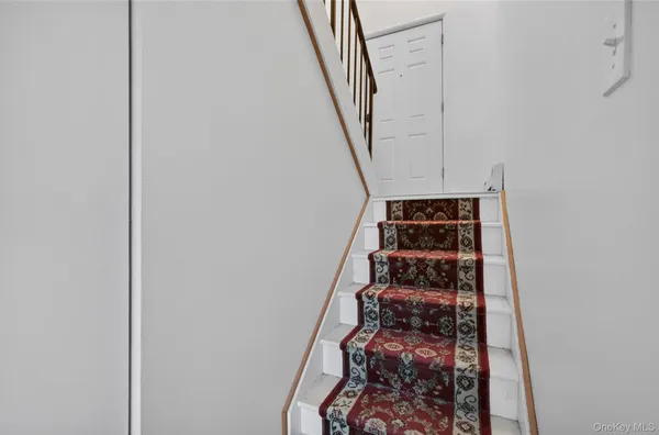 a view of staircase with white walls