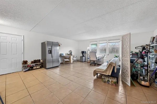 a living room with furniture and a dining table with chairs