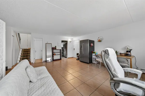 a living room with furniture a desk and chair