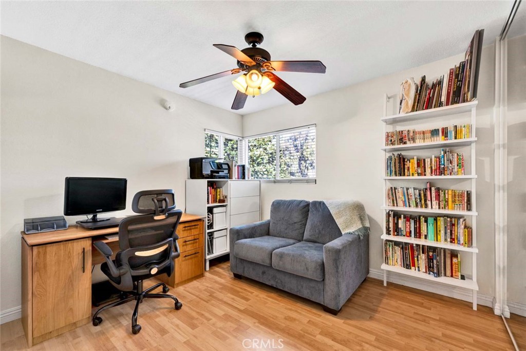 38 Windjammer, Unit 20 Irvine, CA 92614 - Photo 13 of 25 a living room with furniture and a book shelf