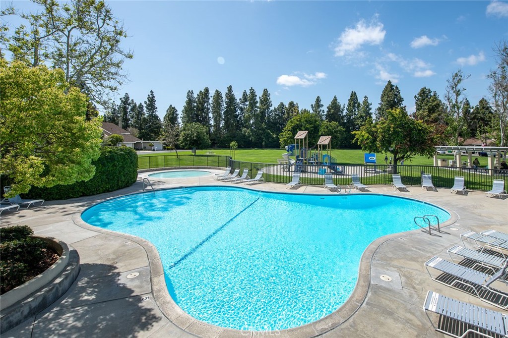 38 Windjammer, Unit 20 Irvine, CA 92614 - Photo 23 of 25 a view of a swimming pool with a patio and a trees