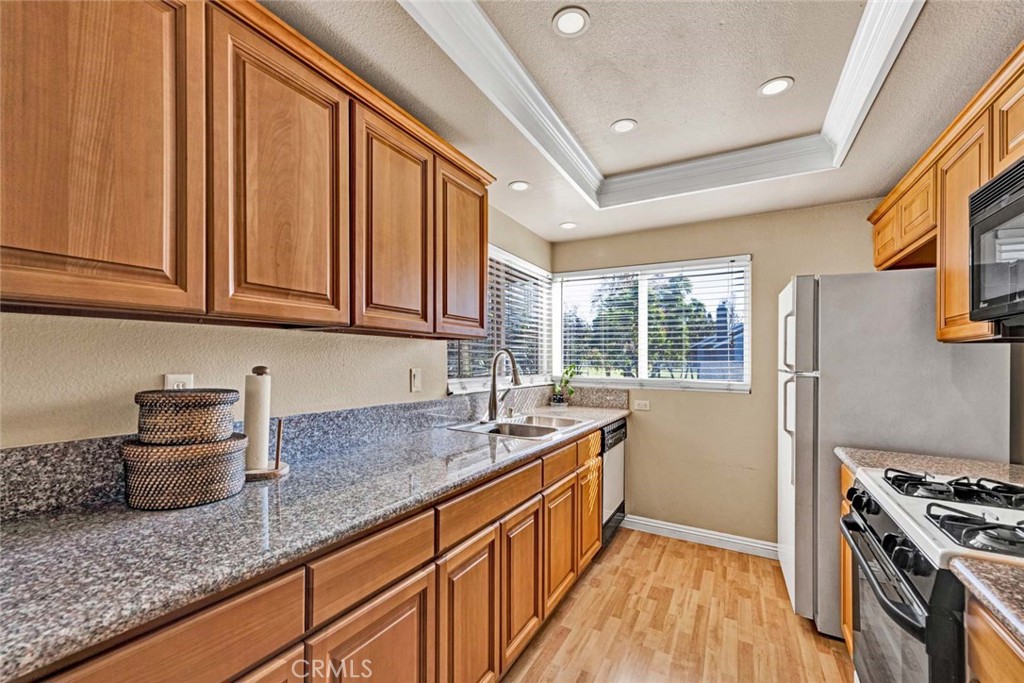 38 Windjammer, Unit 20 Irvine, CA 92614 - Photo 7 of 25 a kitchen with stainless steel appliances granite countertop a sink stove and cabinets