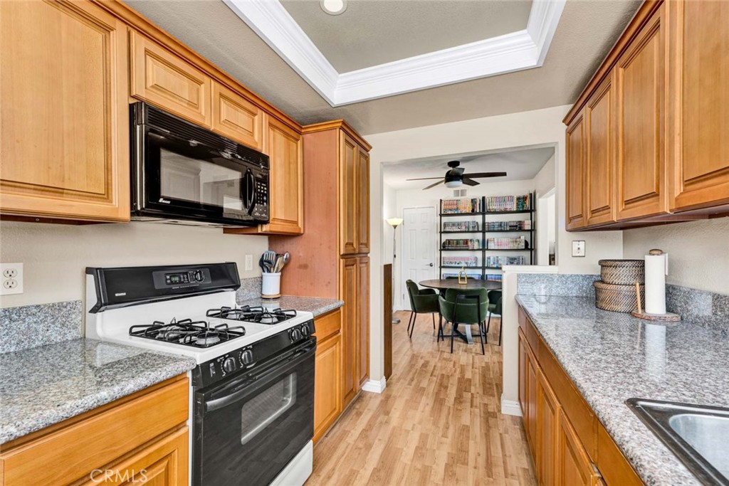38 Windjammer, Unit 20 Irvine, CA 92614 - Photo 8 of 25 a kitchen with a stove and a microwave