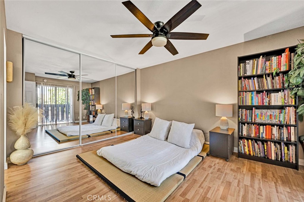 38 Windjammer, Unit 20 Irvine, CA 92614 - Photo 9 of 25 a bedroom with a bed a large window and a chandelier