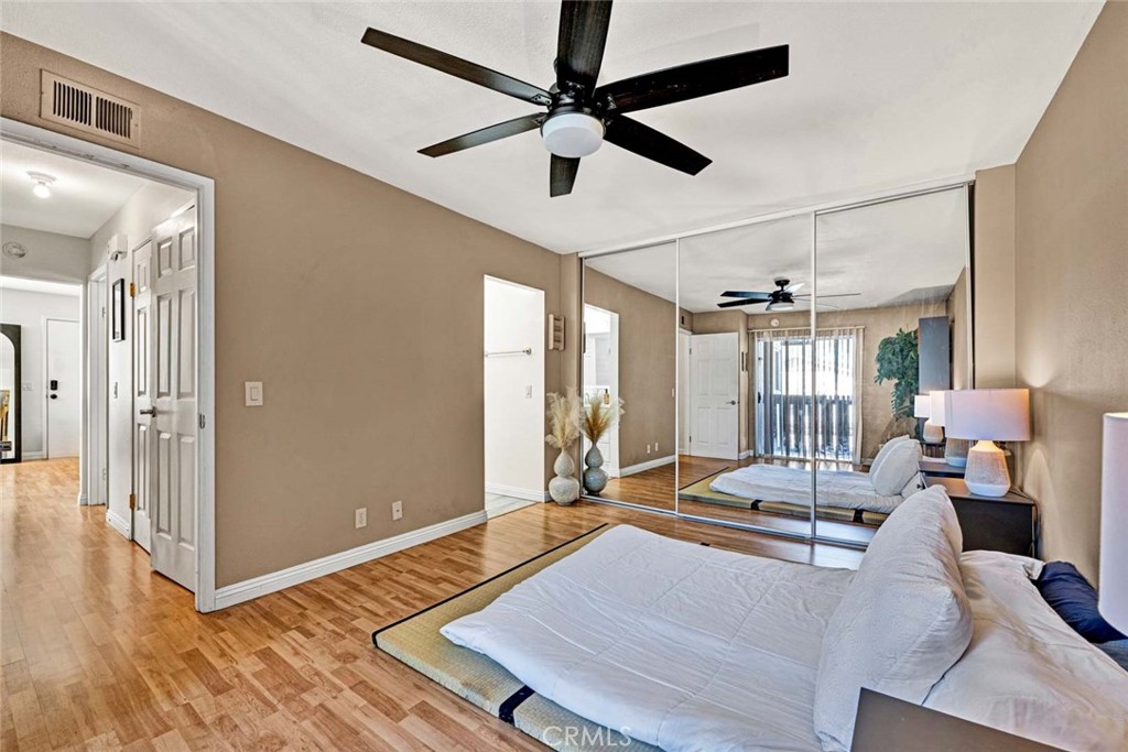 38 Windjammer, Unit 20 Irvine, CA 92614 - Photo 10 of 25 a living room with hardwood floor and a ceiling fan