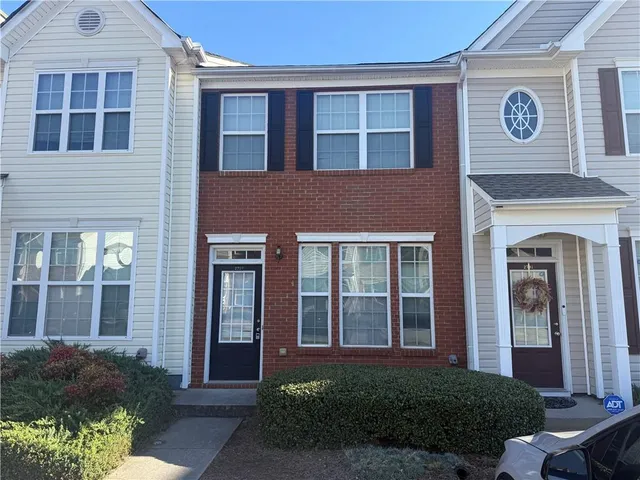 a view of a brick house with a large windows
