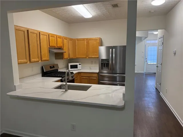 a kitchen with a sink stove and microwave