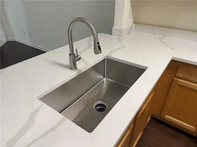 a kitchen with a refrigerator and a sink