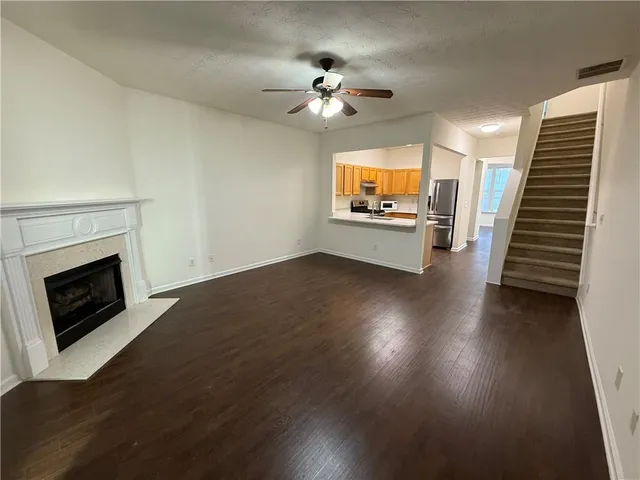 wooden floor fireplace and window in an empty room