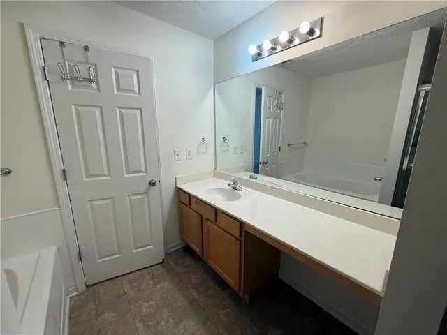 a bathroom with a glass shower door