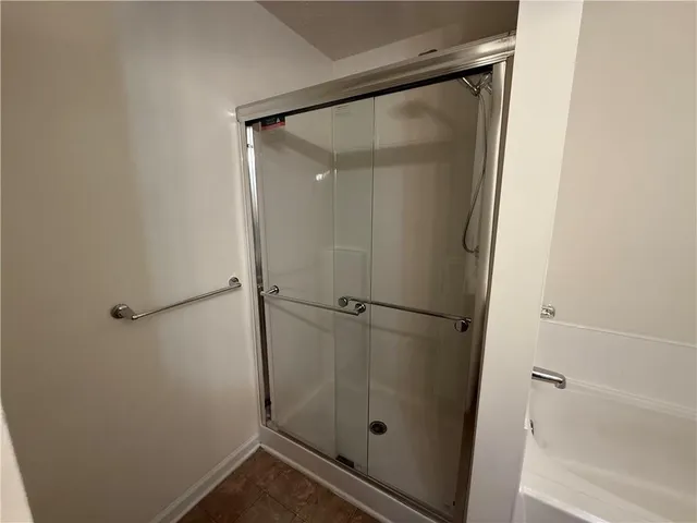 en empty room with windows and fan