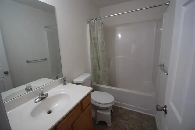 a view of a house with a door and wooden wall