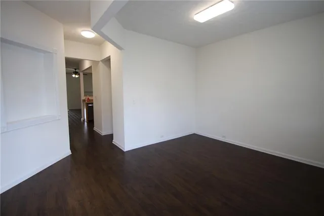 an empty room with wooden floor and closet