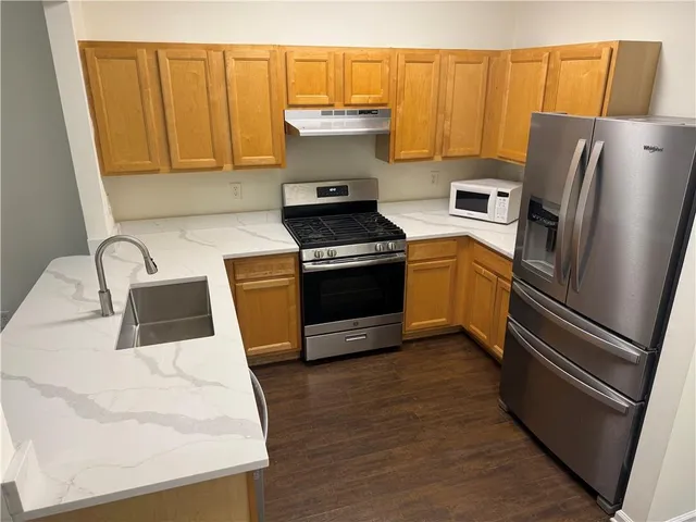 a kitchen with stainless steel appliances a refrigerator and a stove