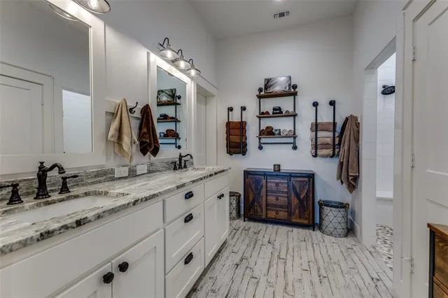 a spacious bathroom with a sink double vanity and a mirror