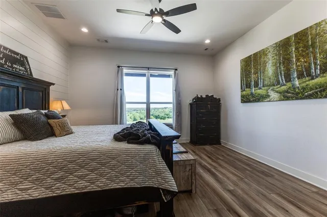 a bedroom with a bed and a large window