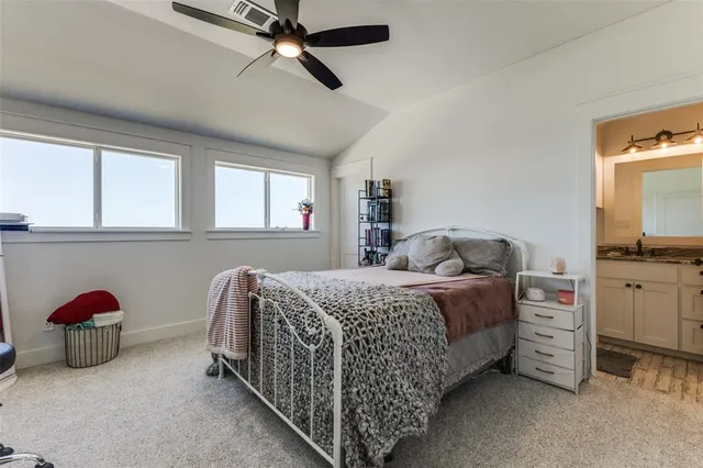 a bedroom with a bed dresser and window