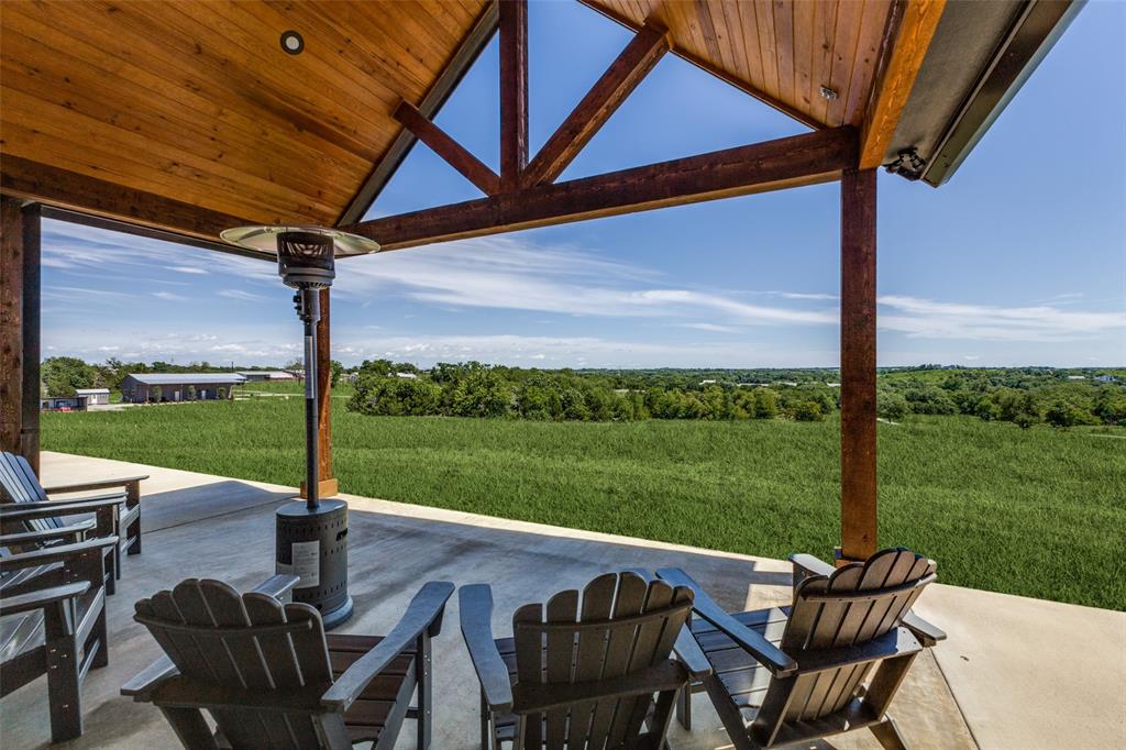 917 Marlow Road Bells, TX 75414 - Photo 24 of 40 a view of a patio with table and chairs under an umbrella
