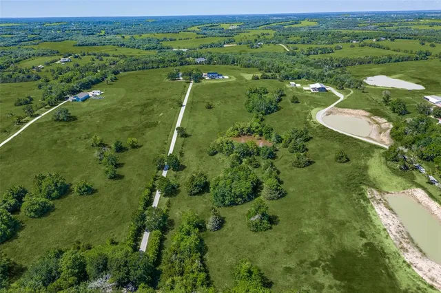 a view of a city with lush green forest