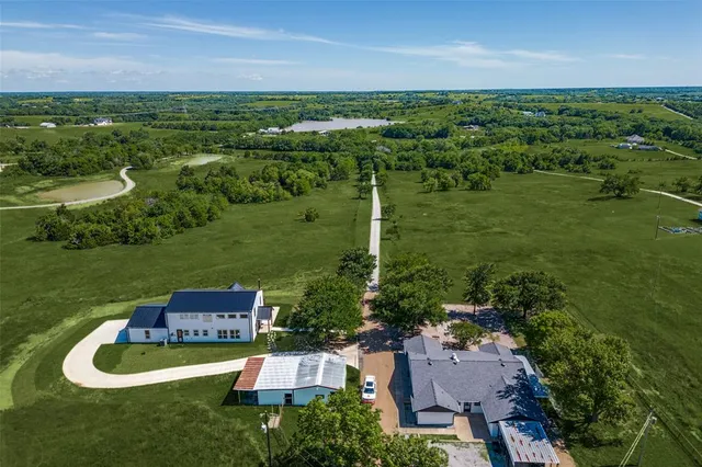an aerial view of a house with a yard