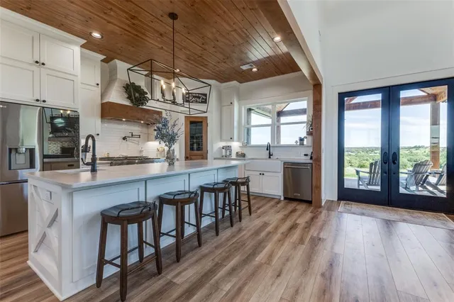 a open kitchen with stainless steel appliances granite countertop a lot of counter space and wooden floors