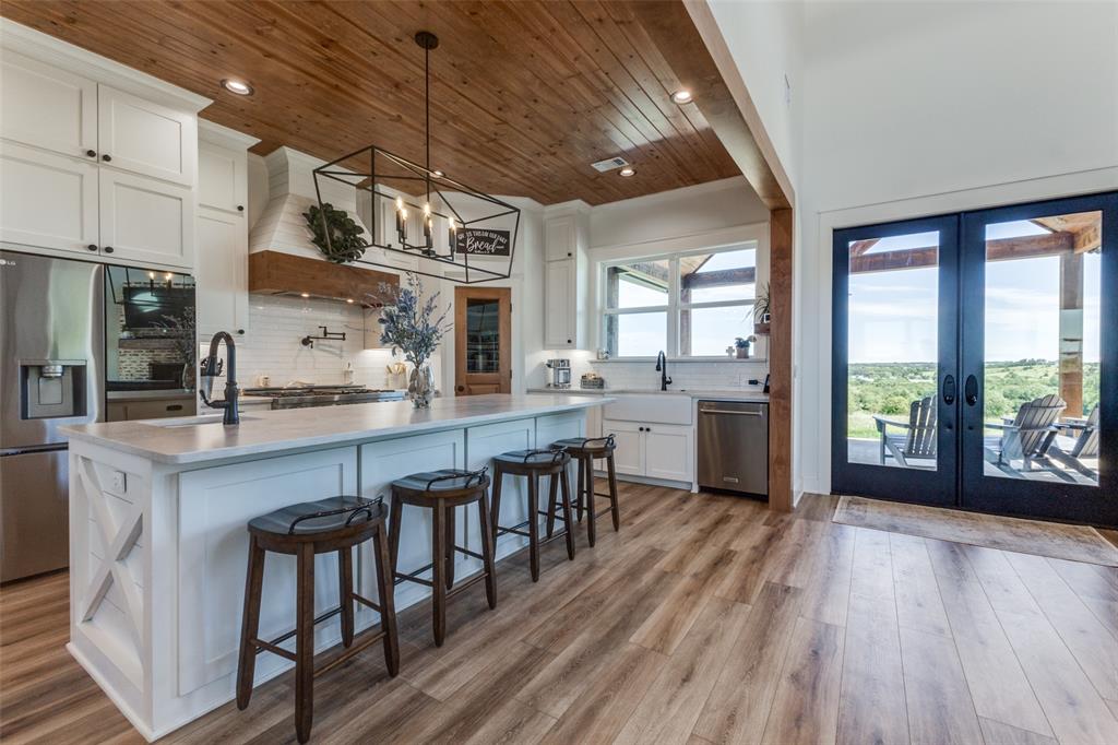 917 Marlow Road Bells, TX 75414 - Photo 9 of 40 a open kitchen with stainless steel appliances granite countertop a lot of counter space and wooden floors