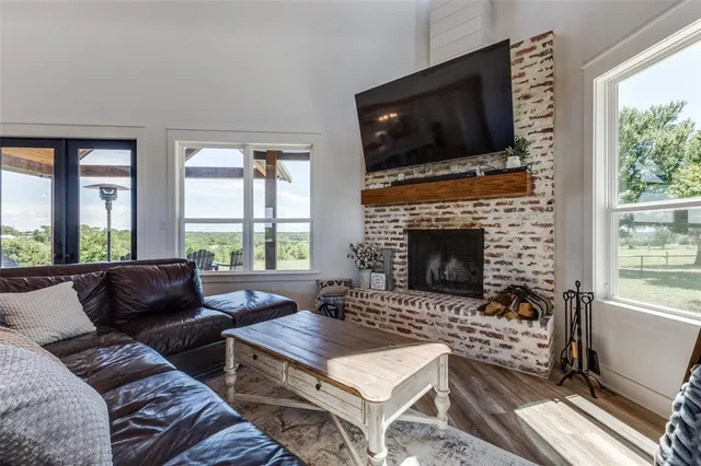 a living room with furniture a flat screen tv and a fireplace