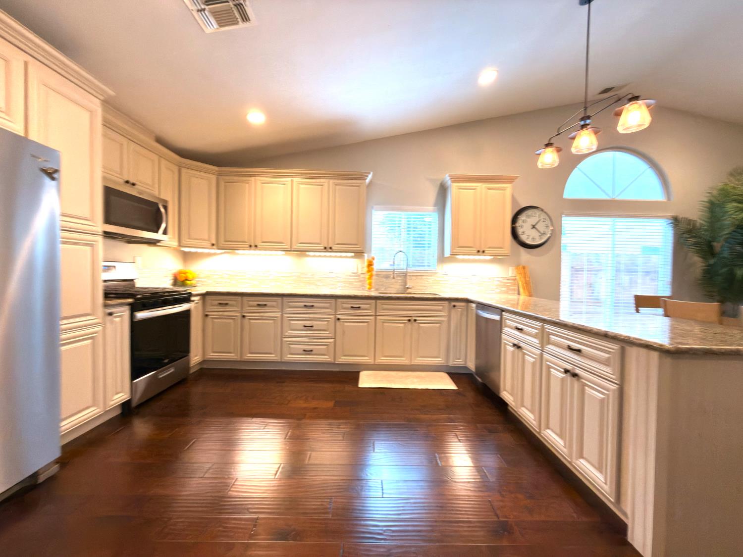 775 Oldenburg Way Galt, CA 95632 - Photo 11 of 31 a kitchen with stainless steel appliances granite countertop wooden floors and white cabinets