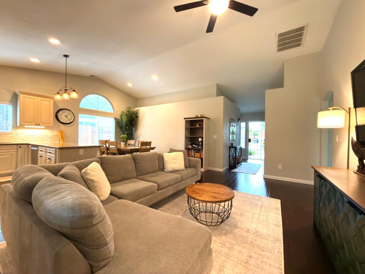 775 Oldenburg Way Galt, CA 95632 - Photo 14 of 31 a living room with furniture a fireplace and a chandelier