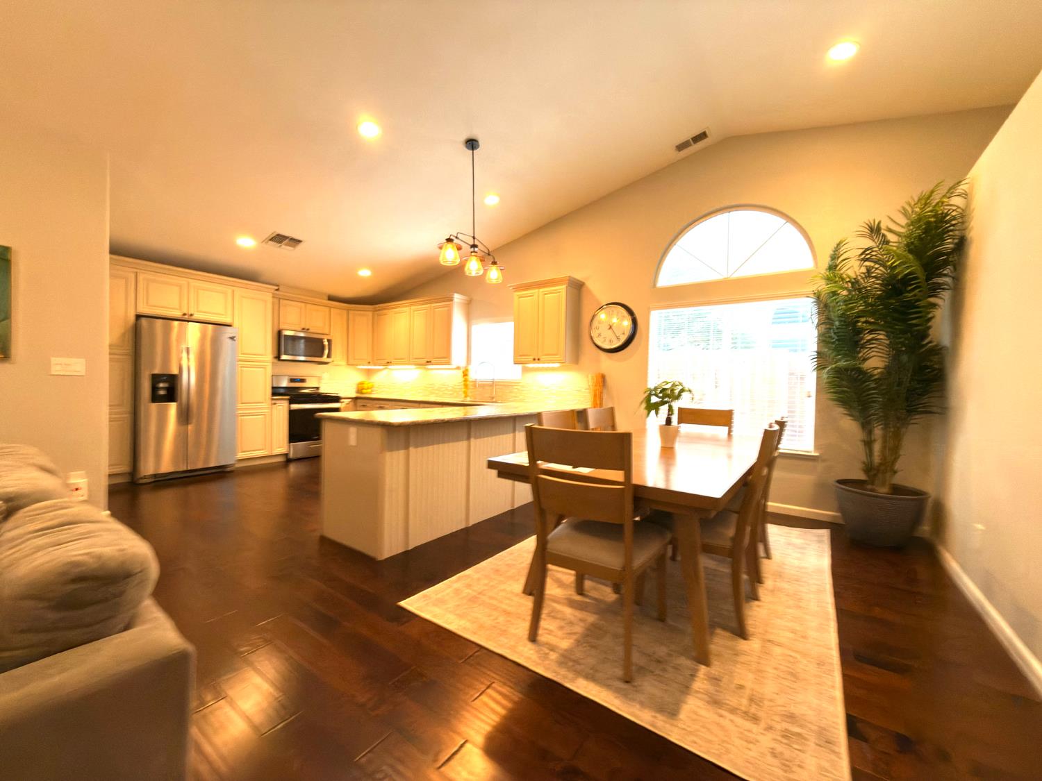 775 Oldenburg Way Galt, CA 95632 - Photo 16 of 31 a living room with couches chairs and kitchen view with wooden floor