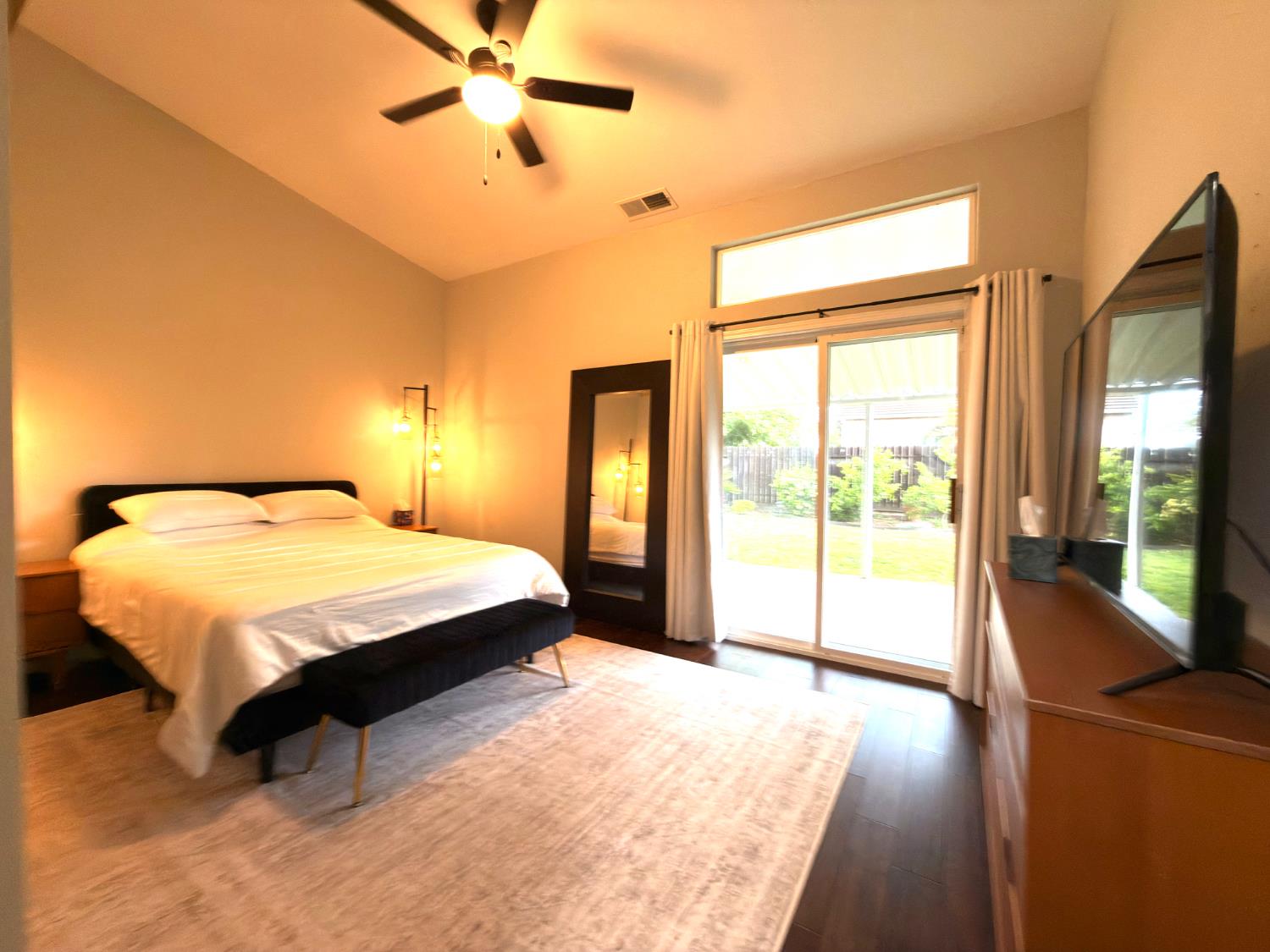 775 Oldenburg Way Galt, CA 95632 - Photo 17 of 31 a spacious bedroom with a large bed and a chandelier