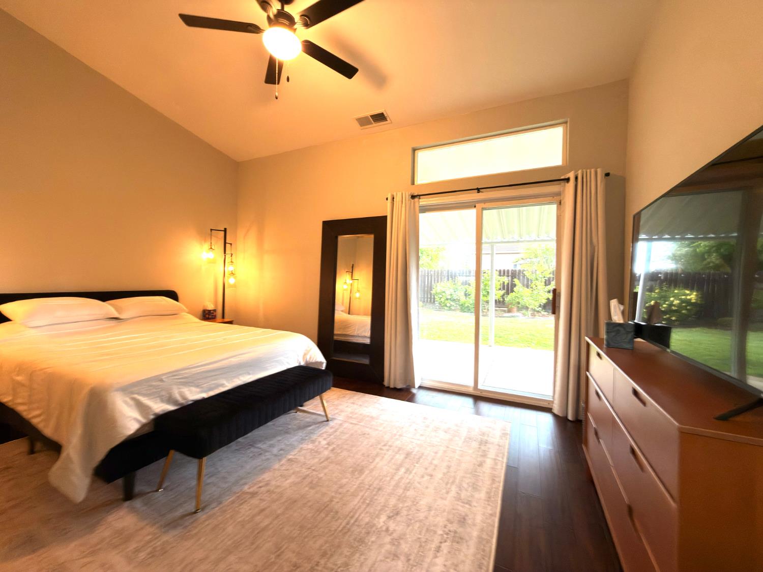 775 Oldenburg Way Galt, CA 95632 - Photo 18 of 31 a spacious bedroom with a large bed and a chandelier