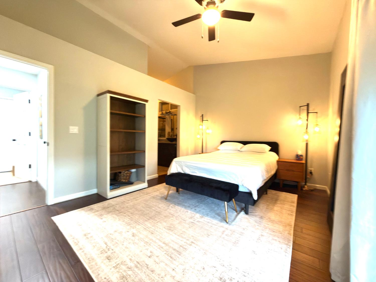 775 Oldenburg Way Galt, CA 95632 - Photo 19 of 31 a spacious bedroom with a large bed and a chandelier