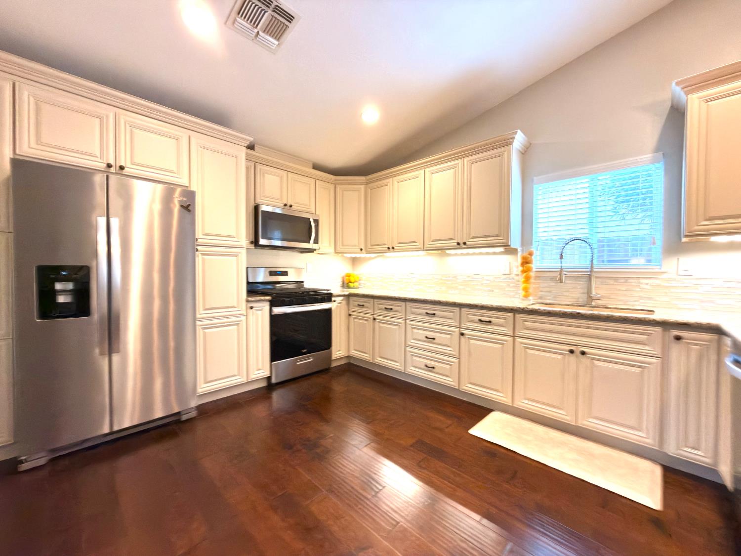 775 Oldenburg Way Galt, CA 95632 - Photo 8 of 31 a kitchen with granite countertop white cabinets and stainless steel appliances