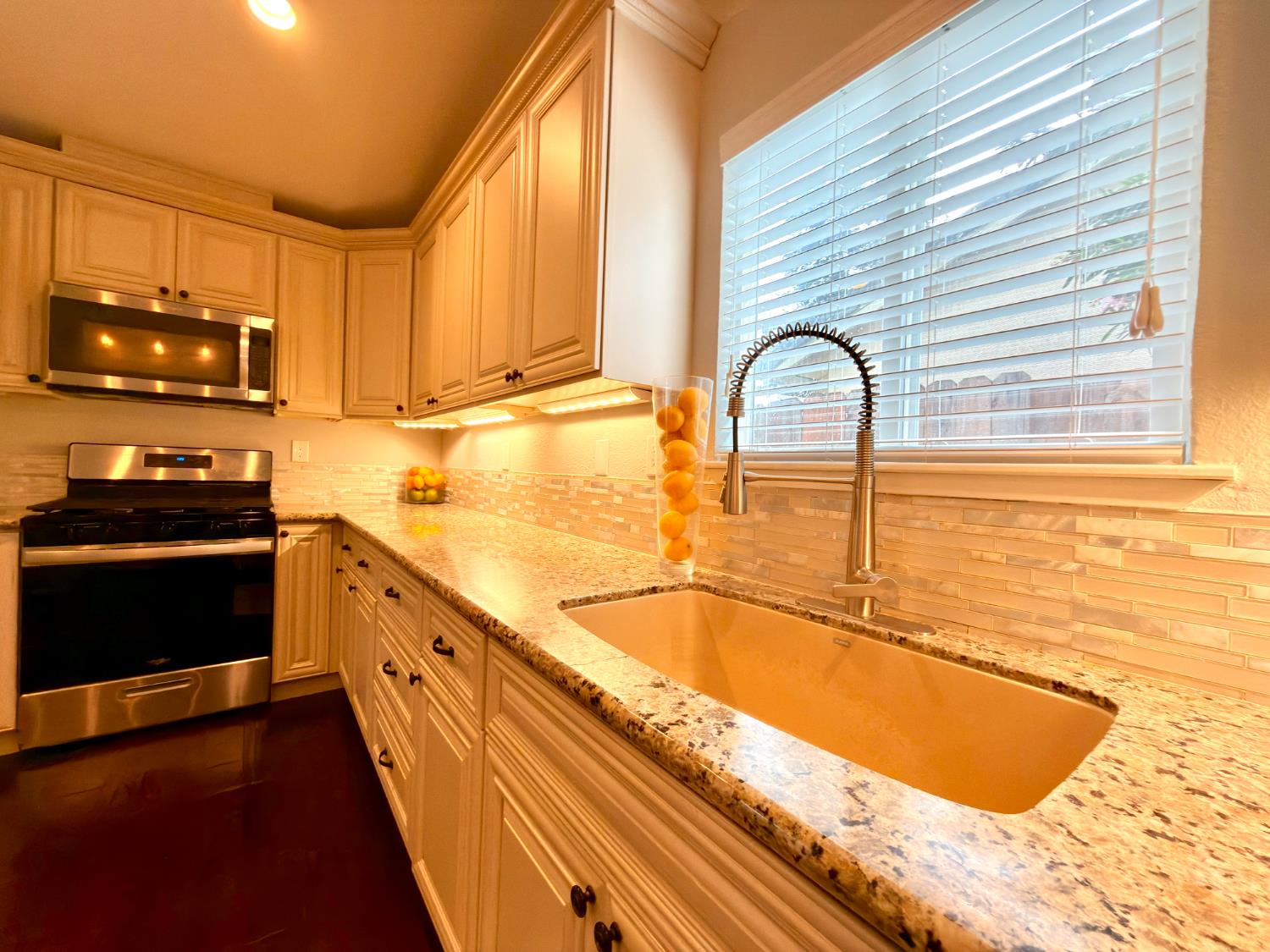 775 Oldenburg Way Galt, CA 95632 - Photo 10 of 31 a kitchen with granite countertop a stove and a sink