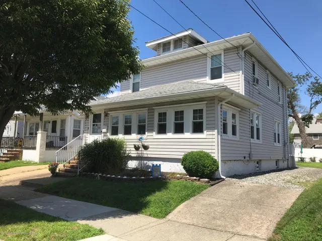 a front view of a house with garden and porch