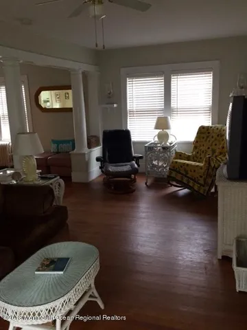 a living room with furniture and a wooden floor