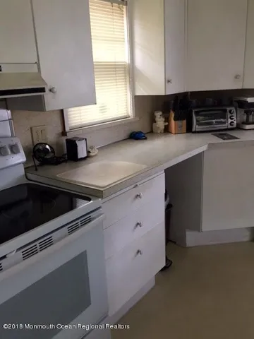 a kitchen with stainless steel appliances a sink stove and cabinets