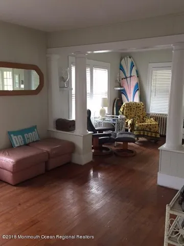 a living room with furniture a rug and a window