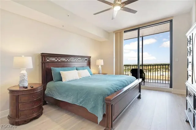 a bedroom with a bed window and a ceiling fan