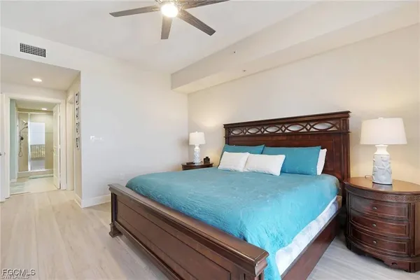 a bedroom with a bed and a lamp