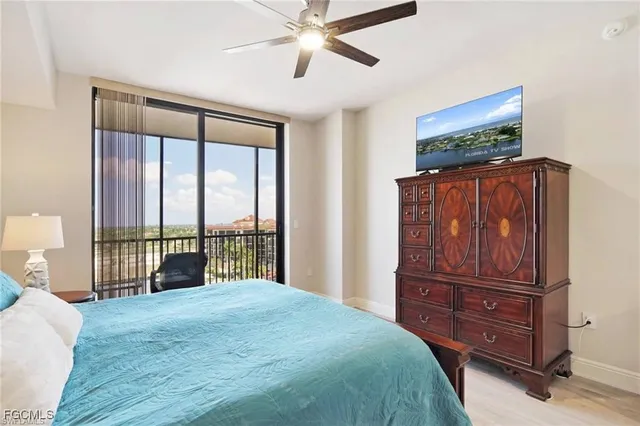 a bedroom with a bed and large windows