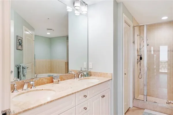 a bathroom with a granite countertop sink mirror and double