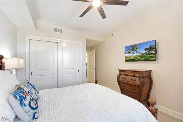 a bedroom with a bed and a painting on the wall